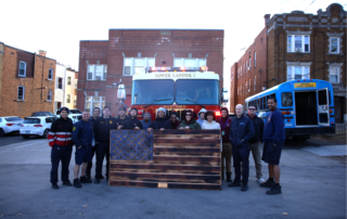 Photos of Carpentry students presenting the large wooden American flag to the firefighters and touring the facility.